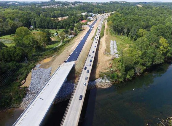 An aerial view of the old and new Hwy. 20 bridges over the Chattahoochee River shows the new one on the left has shoulders and is higher than the original bridge built in 1947.