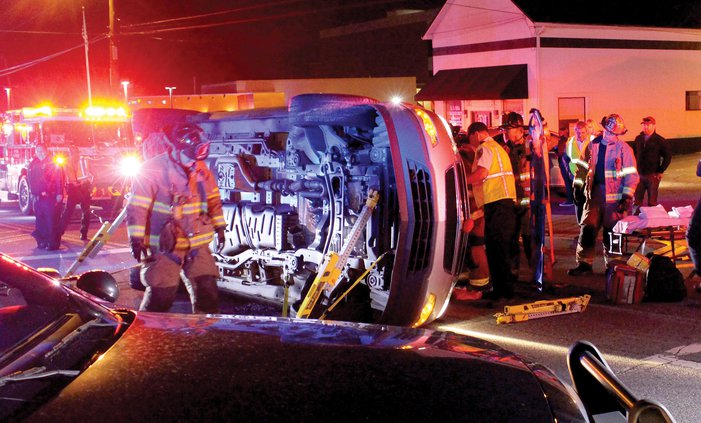 Firefighters work to free a woman trapped in her SUV